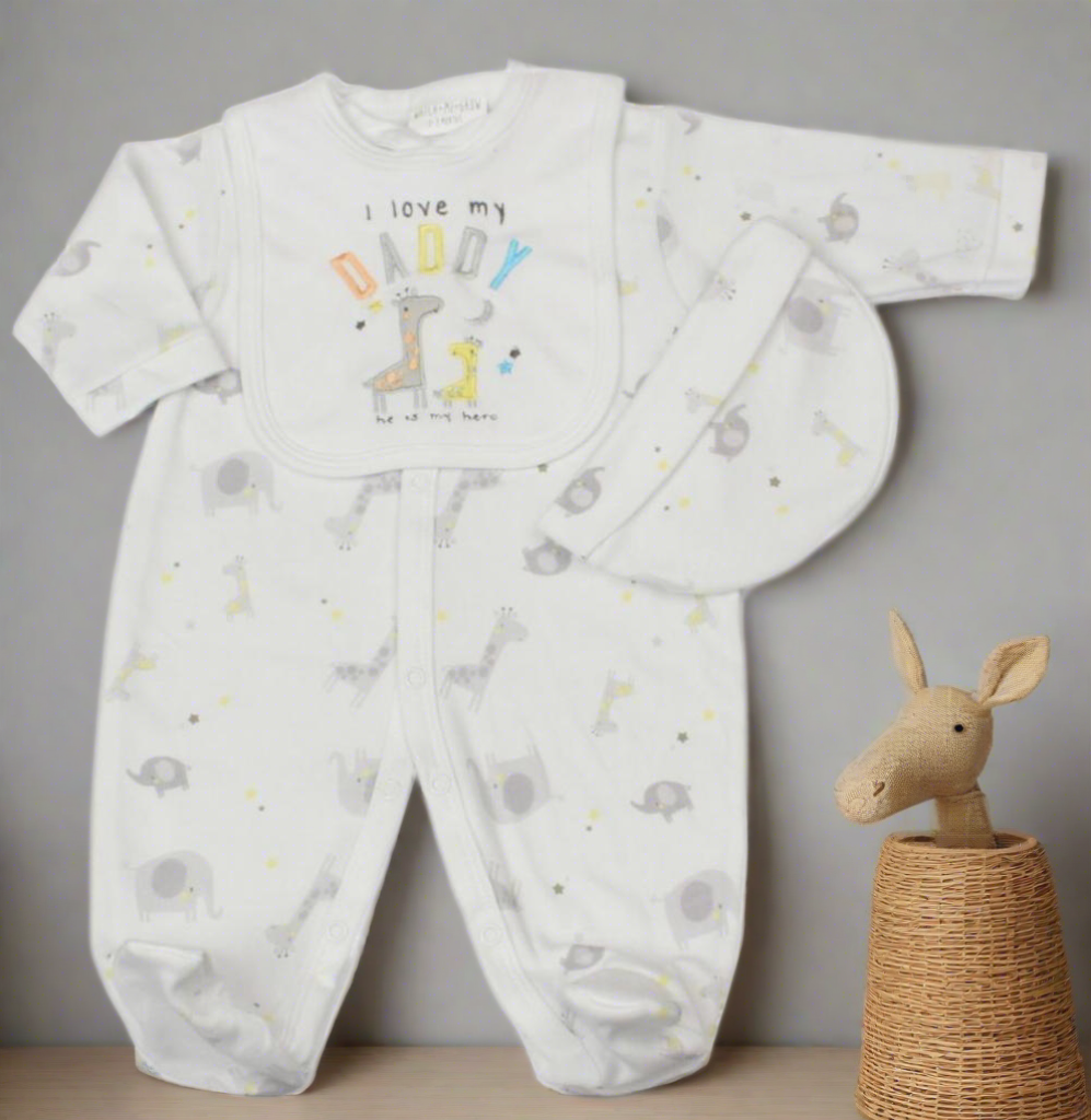 Unisex baby clothes set - Image of white three-piece baby clothes set with giraffe theme, featuring 'I Love My Daddy' embroidery. Includes bib, hat and sleepsuit. (Front Angle in safari nursery)