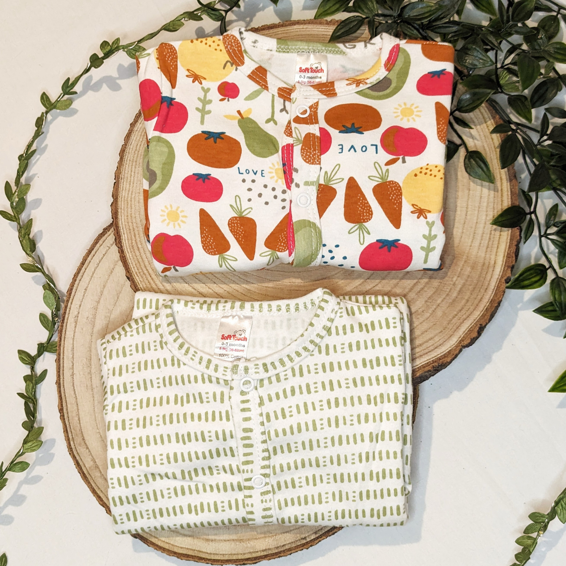 Two vibrant vegetable-themed baby sleepsuits made of 100% cotton for ultimate comfort, with matching accessories available
