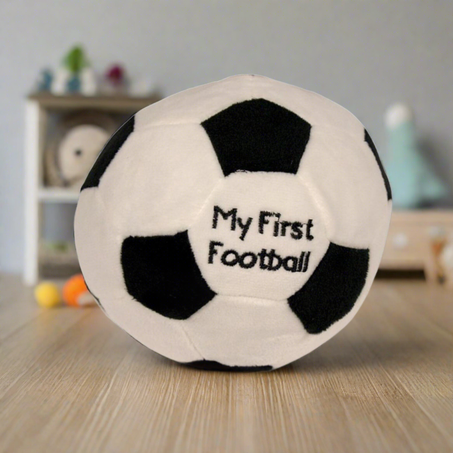 Soft baby toy, my first football. Measuring 15cm made from soft plush materials with a rattle sound within. (Featured in a nursery background)