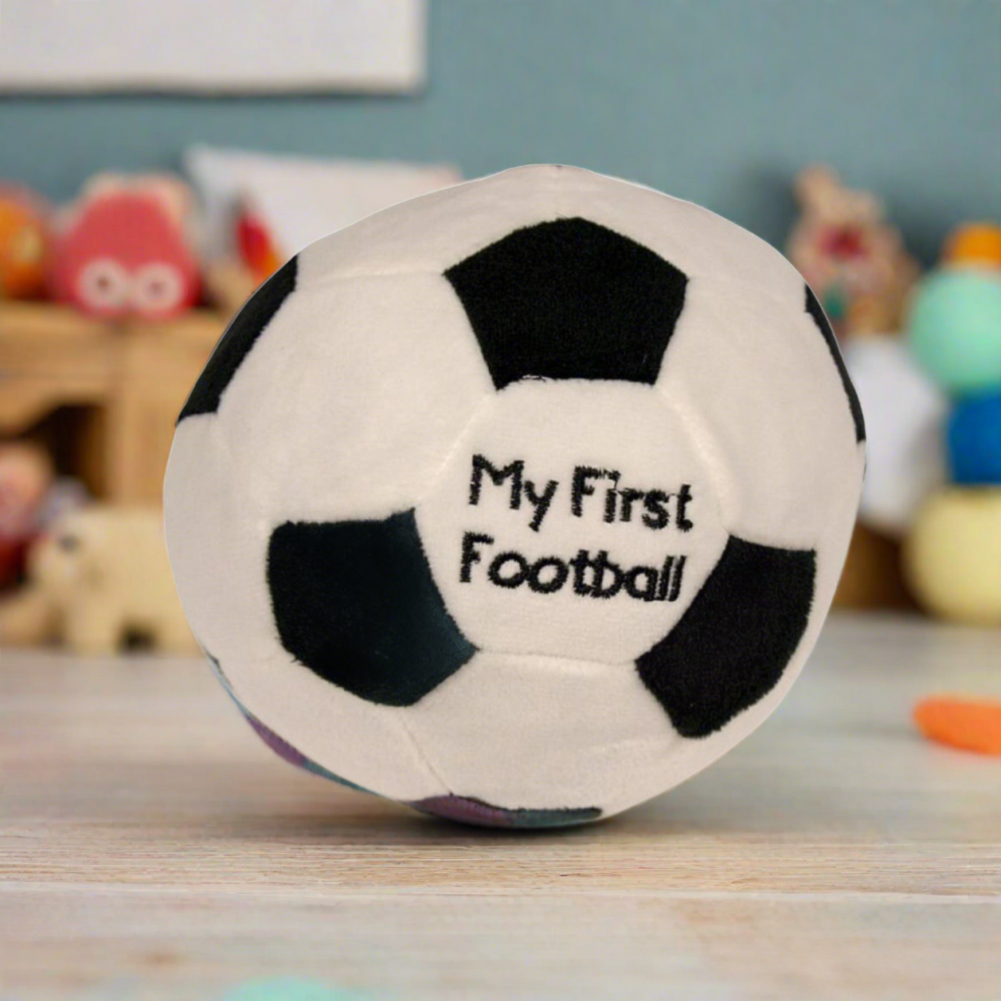 Soft baby toy, my first football. Measuring 15cm made from soft plush materials with a rattle sound within. (Featured in a a baby playroom)