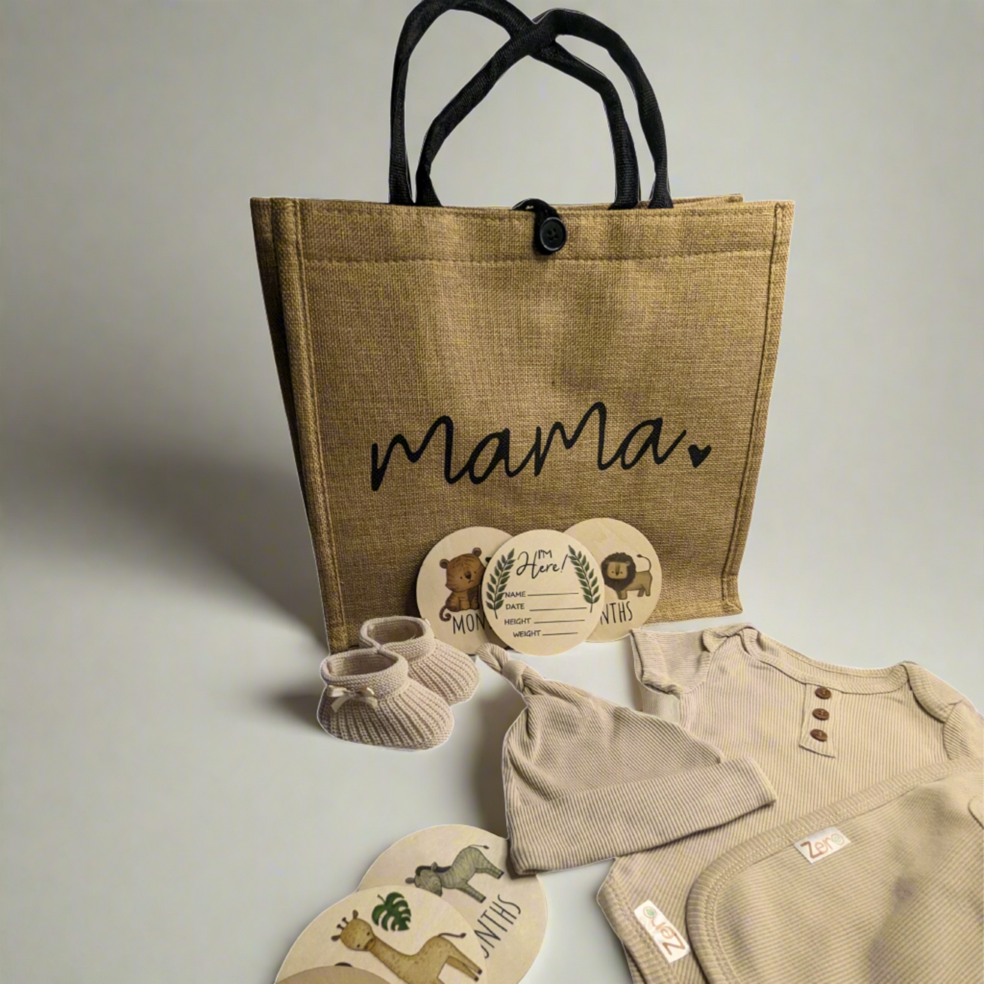 Gift hamper for mummy to be featuring hessian bag, eco-friendly baby clothes, milestone discs, and baby bootie