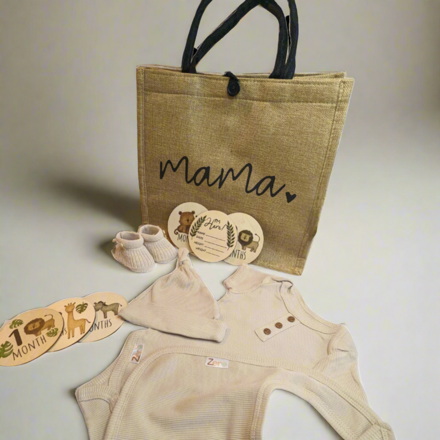 Hessian bag, wooden milestone discs, eco-friendly baby clothes, and knit booties making the perfect mummy to be gift hamper